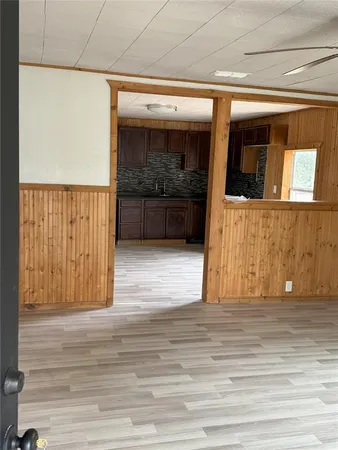 a view of hallway with wooden floor and stairs