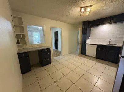 a large kitchen with a stove and a refrigerator