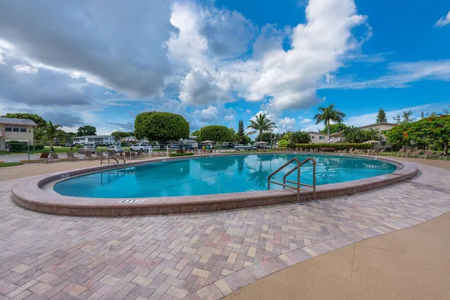 a view of a swimming pool with a yard