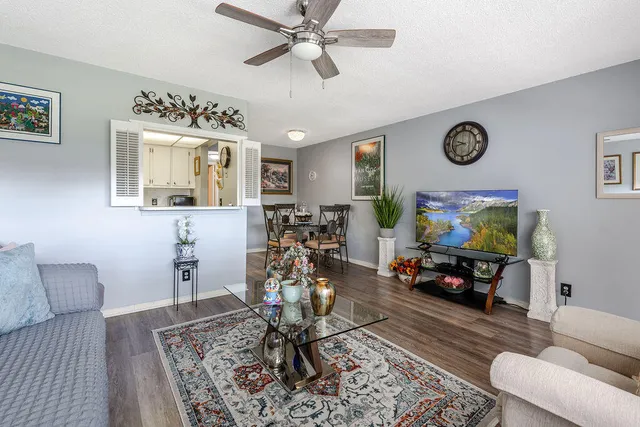 a living room with furniture a window and a flat screen tv