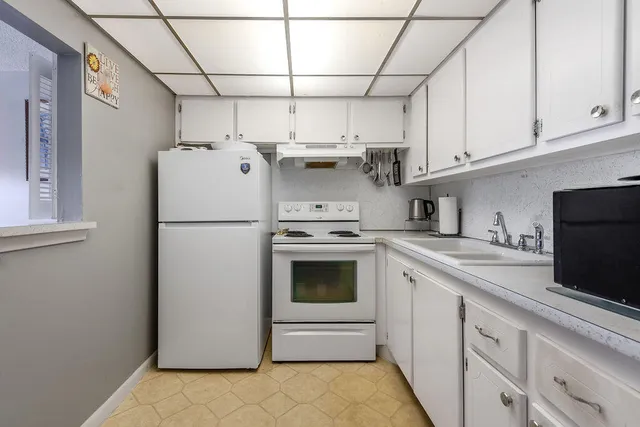 a kitchen with stainless steel appliances granite countertop a refrigerator sink and cabinets