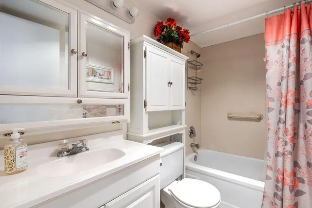 a bathroom with a sink toilet tub and shower