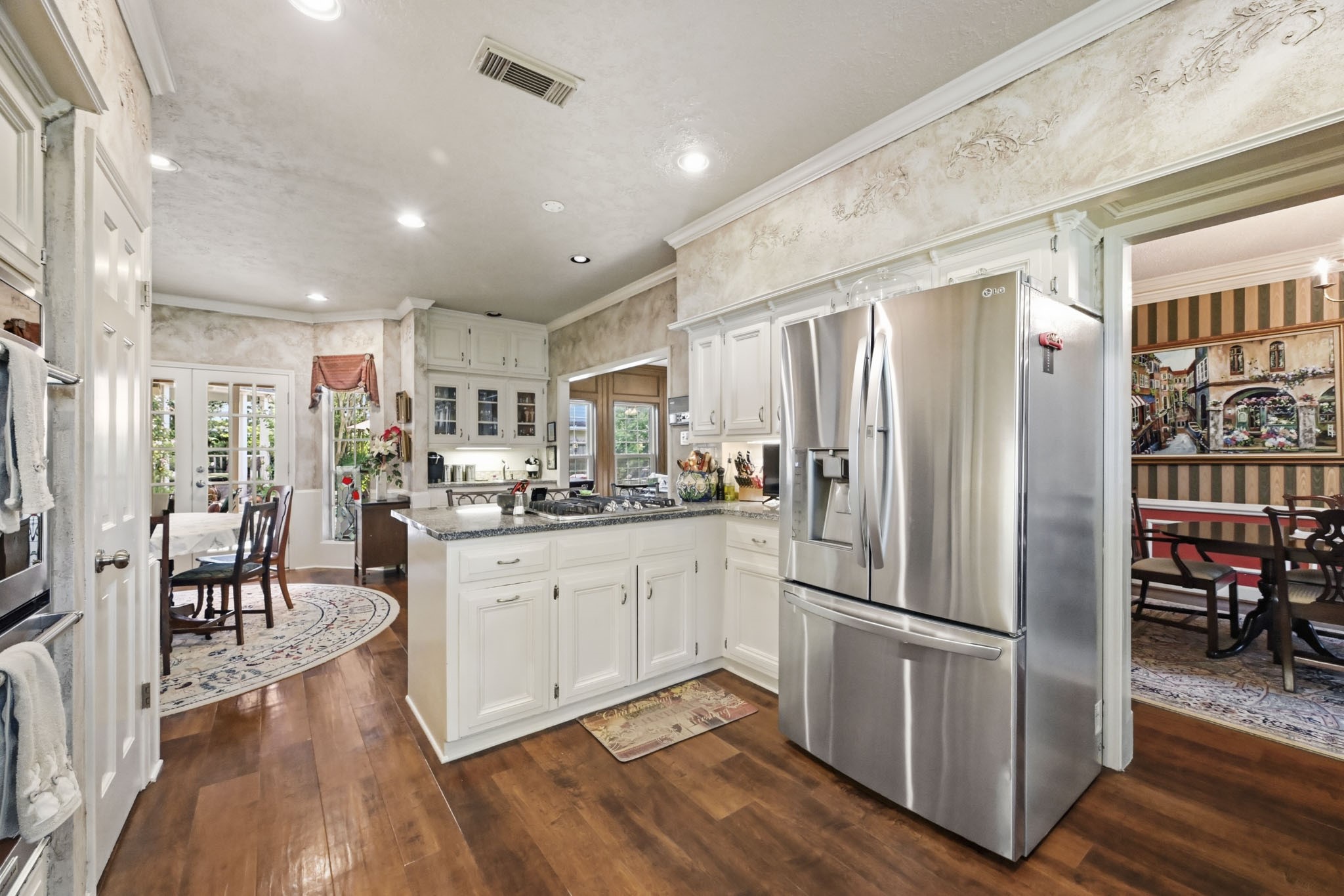 16030 Rudgewick Lane Spring, TX 77379 - Photo 18 of 50 There is a swinging door between the kitchen and dining room to close off the kitchen for dinner parties. At the far end of the room are the French doors to the patio and pool.