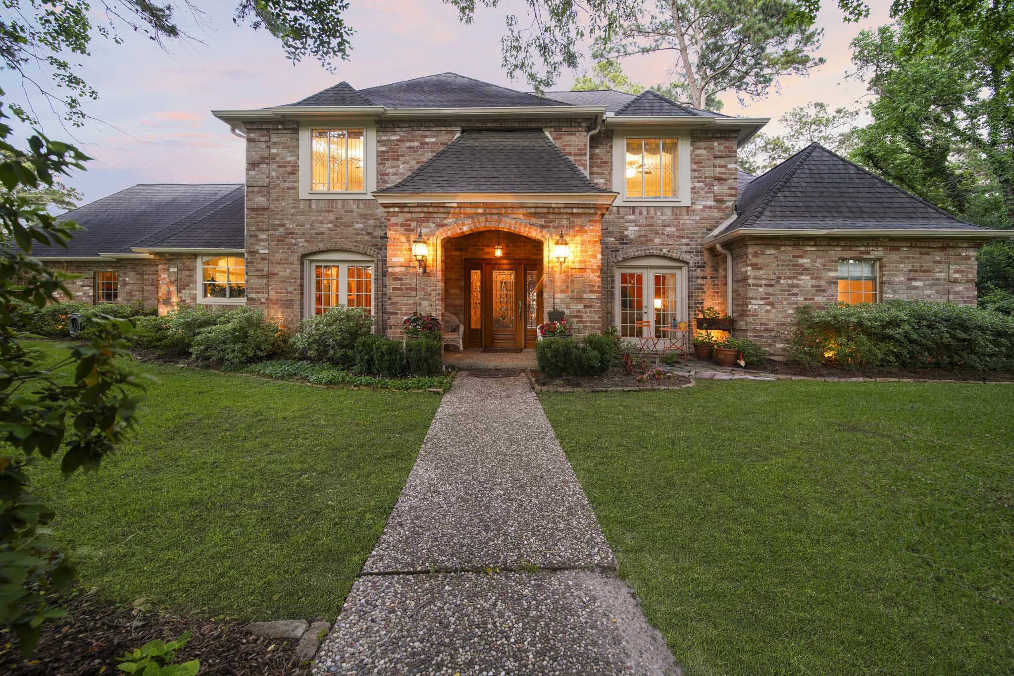 16030 Rudgewick Lane Spring, TX 77379 - Photo 6 of 50 There is a cute sitting area to the right with a table, plantings and garden gnomes where you can sit outside and over your morning coffee, say hello to walkers going by .