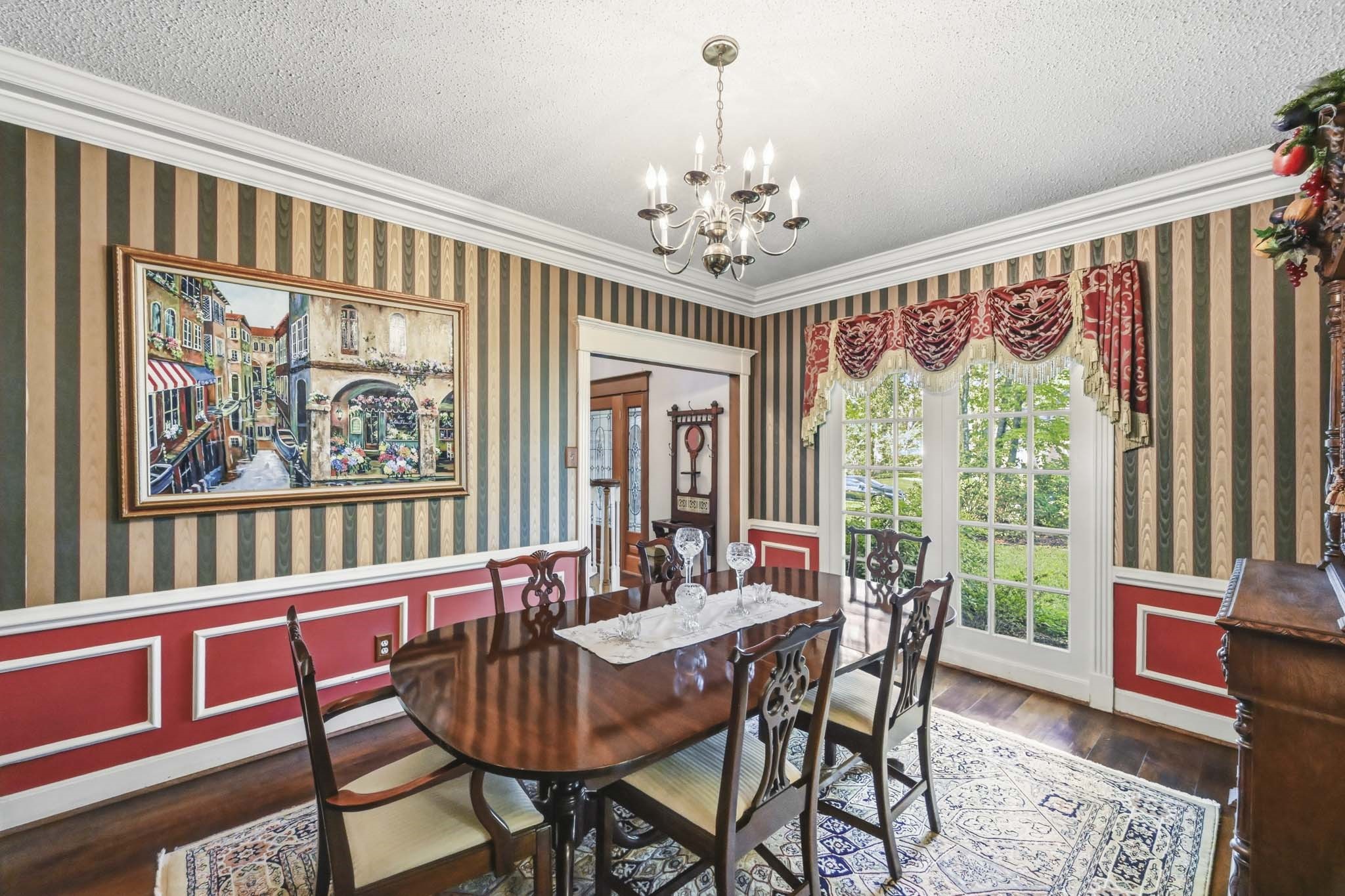16030 Rudgewick Lane Spring, TX 77379 - Photo 10 of 50 The dining room has room for large service furniture and a table that can seat 8 easily. A swinging door to the right of the photo leads to the kitchen for ease of serving at your dinner party The room boasts double crown moldings and a chair rail.