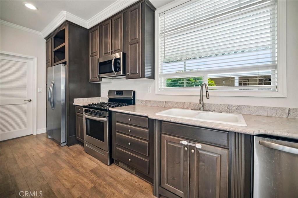 250 East Telegraph Road, Unit 307 Fillmore, CA 93015 - Photo 13 of 36 a kitchen with stainless steel appliances granite countertop a sink stove and refrigerator