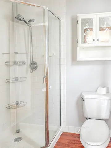 a white toilet next to a bathroom sink
