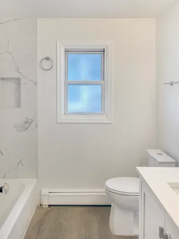 a bathroom with a toilet a sink and bathtub