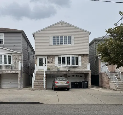 a front view of a house with parking space