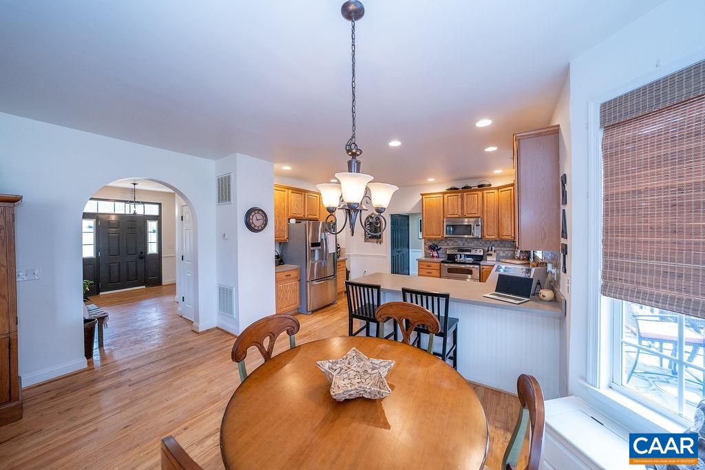 60 Pine Ridge Road Faber, VA 22938 - Photo 19 of 74 a view of a dining room and livingroom with furniture wooden floor a chandelier