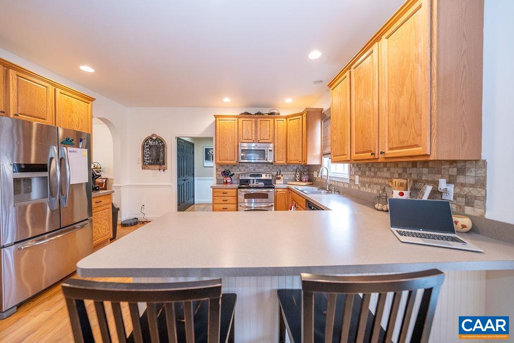 60 Pine Ridge Road Faber, VA 22938 - Photo 20 of 74 a kitchen with stainless steel appliances a stove a refrigerator a sink and a counter