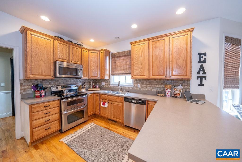 60 Pine Ridge Road Faber, VA 22938 - Photo 27 of 74 a kitchen with stainless steel appliances granite countertop wooden cabinets a sink and a stove