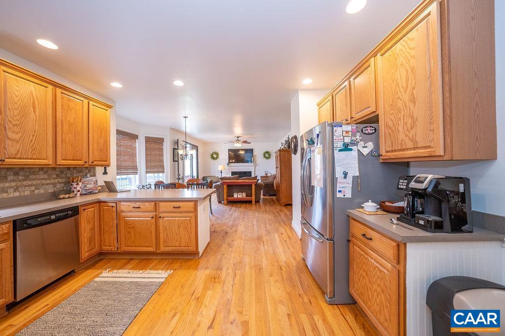 60 Pine Ridge Road Faber, VA 22938 - Photo 28 of 74 a kitchen with stainless steel appliances granite countertop a refrigerator a sink dishwasher a stove and white countertops with wooden floor