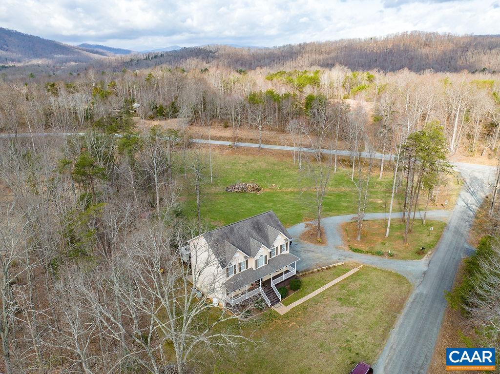 60 Pine Ridge Road Faber, VA 22938 - Photo 31 of 74 a view of a lake with couches in the patio and a yard