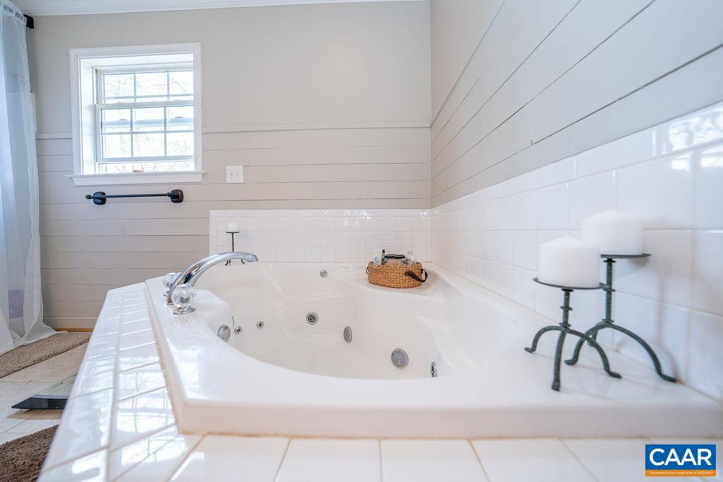 60 Pine Ridge Road Faber, VA 22938 - Photo 48 of 74 a bathroom with a bathtub and a window