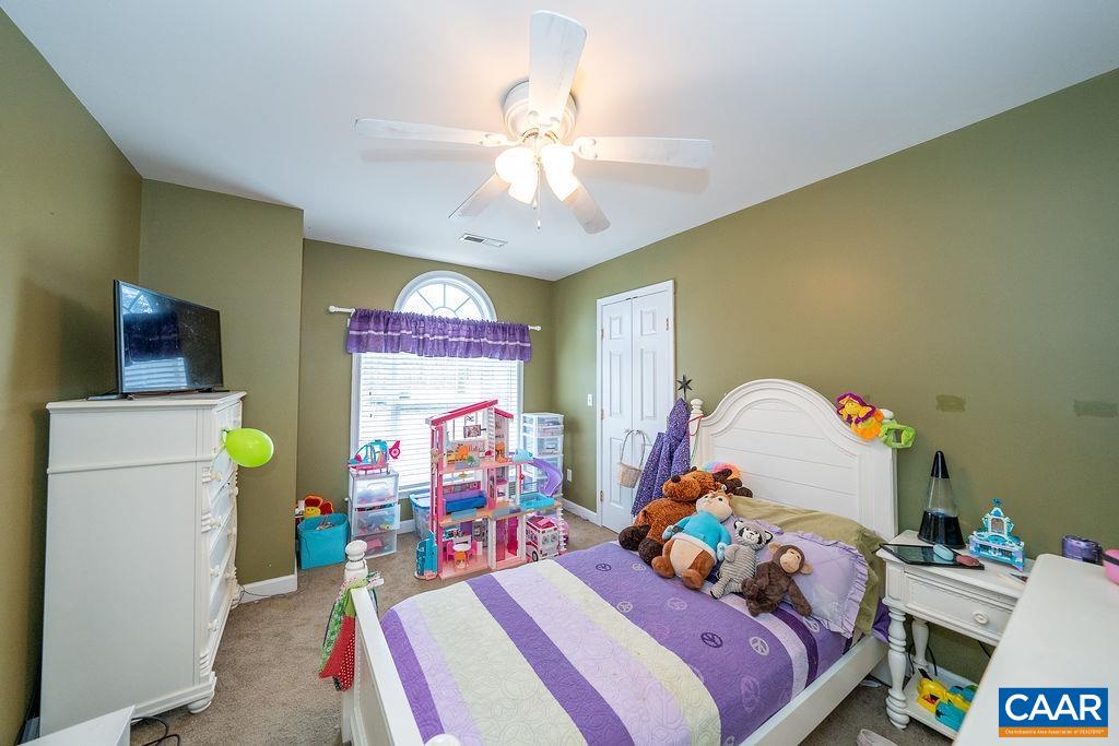 60 Pine Ridge Road Faber, VA 22938 - Photo 53 of 74 a bedroom with a bed and a chandelier