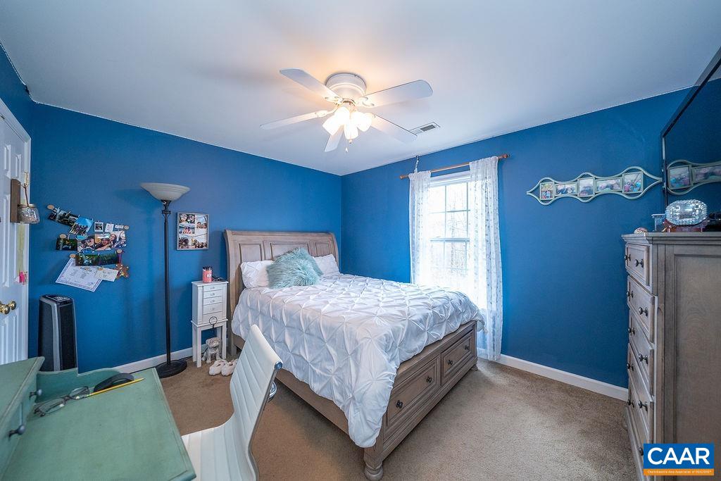 60 Pine Ridge Road Faber, VA 22938 - Photo 56 of 74 a bed room with a bed and a chandelier