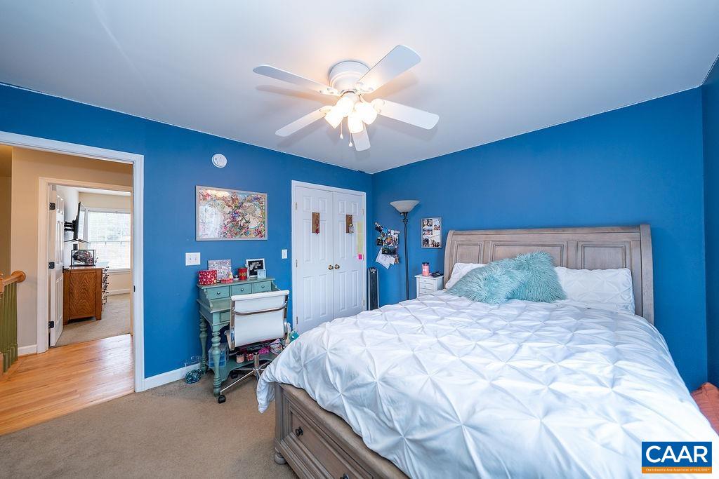 60 Pine Ridge Road Faber, VA 22938 - Photo 57 of 74 a bedroom with a bed and a chandelier