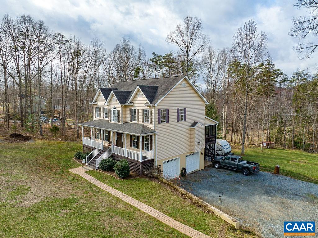 60 Pine Ridge Road Faber, VA 22938 - Photo 58 of 74 a view of a white house next to a yard with big trees