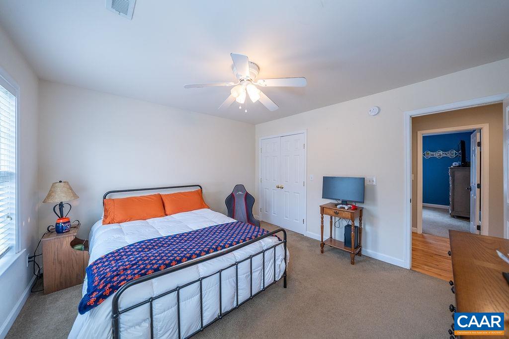 60 Pine Ridge Road Faber, VA 22938 - Photo 62 of 74 a bedroom with a bed and a chandelier