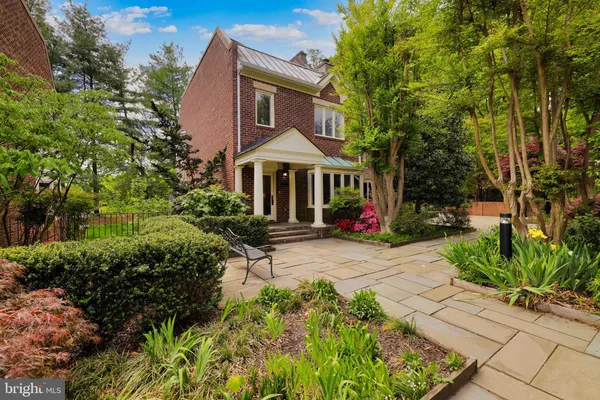 a front view of a house with yard and green space
