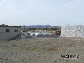 10106 Harbor View Road Parker, AZ 85344 - Photo 1 of 7 a view of a dry yard with wooden fence