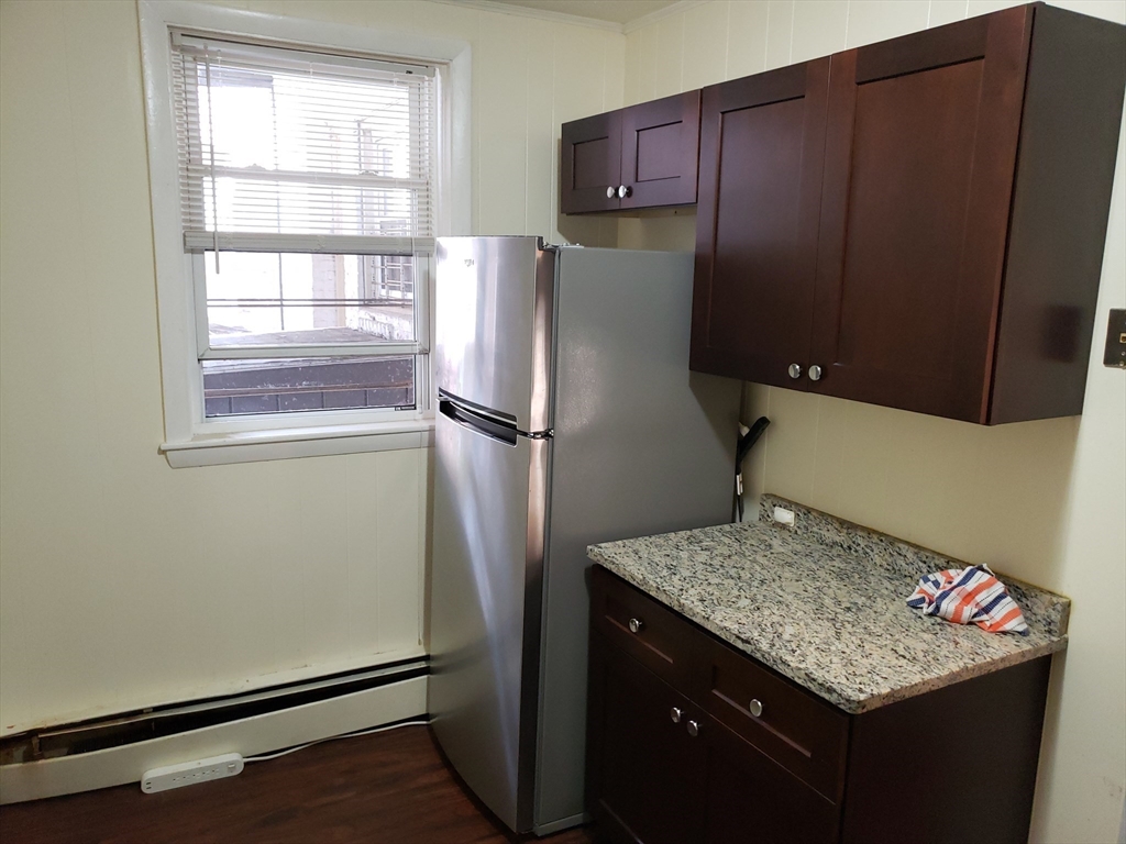 18 Central Avenue, Unit 1 Chelsea, MA 02150 - Photo 1 of 6 a kitchen with stainless steel appliances granite countertop a refrigerator and a cabinets