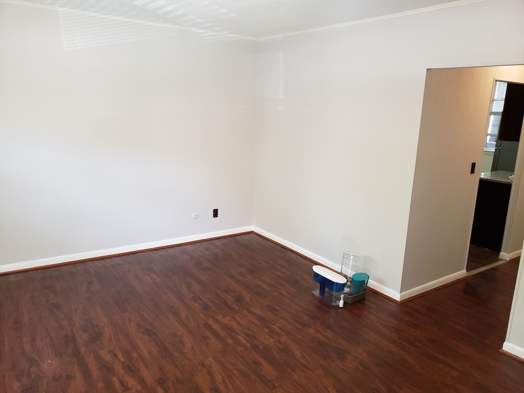 18 Central Avenue, Unit 1 Chelsea, MA 02150 - Photo 3 of 6 an empty room with wooden floor