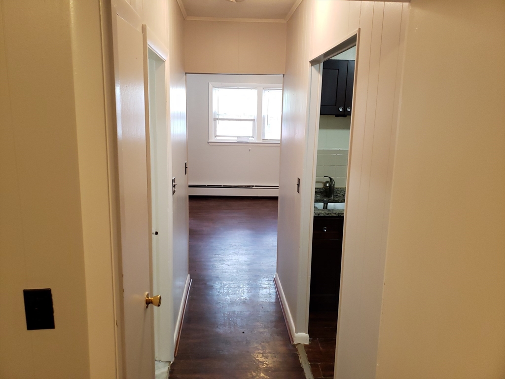 18 Central Avenue, Unit 1 Chelsea, MA 02150 - Photo 4 of 6 a view of a hallway with wooden floor and closet