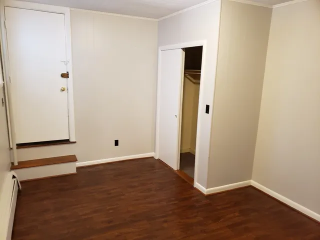 an empty room with wooden floor