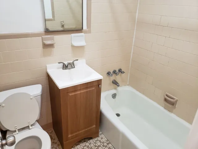 a bathroom with a sink a toilet and bathtub