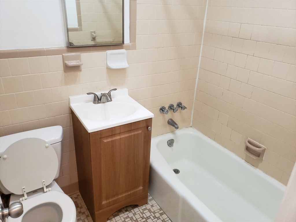 18 Central Avenue, Unit 1 Chelsea, MA 02150 - Photo 6 of 6 a bathroom with a sink a toilet and bathtub