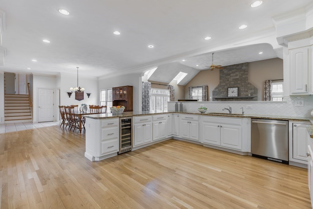 4 Walker Lane Boxford, MA 01921 - Photo 16 of 40 a large kitchen with kitchen island a sink a stove a center island and a window