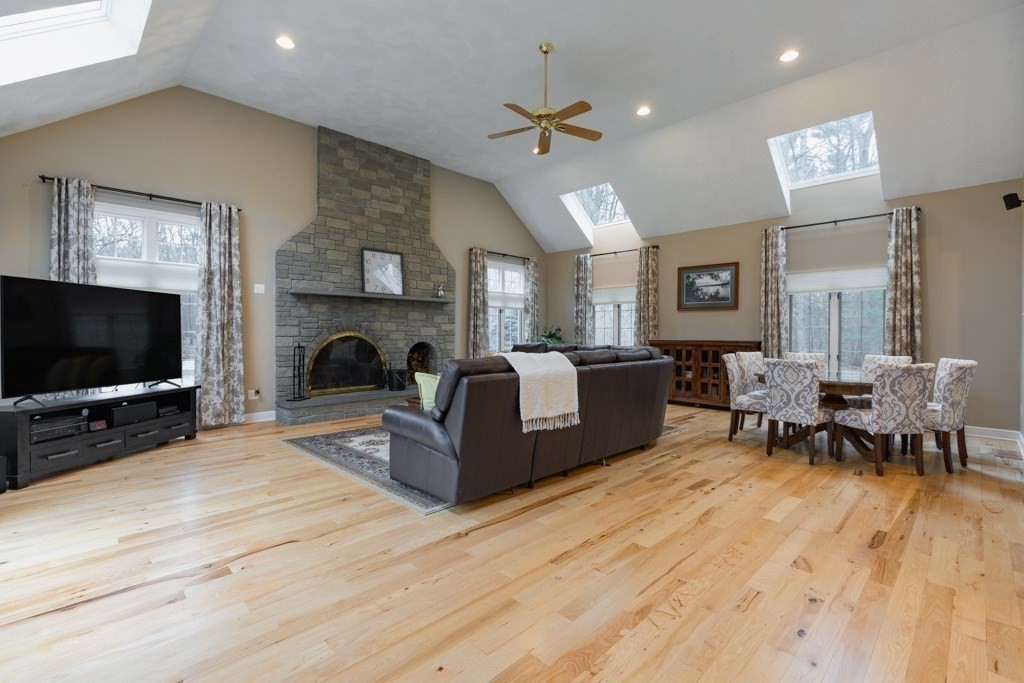 4 Walker Lane Boxford, MA 01921 - Photo 21 of 40 a living room with furniture a flat screen tv and a fireplace