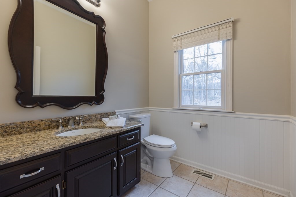 4 Walker Lane Boxford, MA 01921 - Photo 22 of 40 a bathroom with a granite countertop toilet sink and mirror