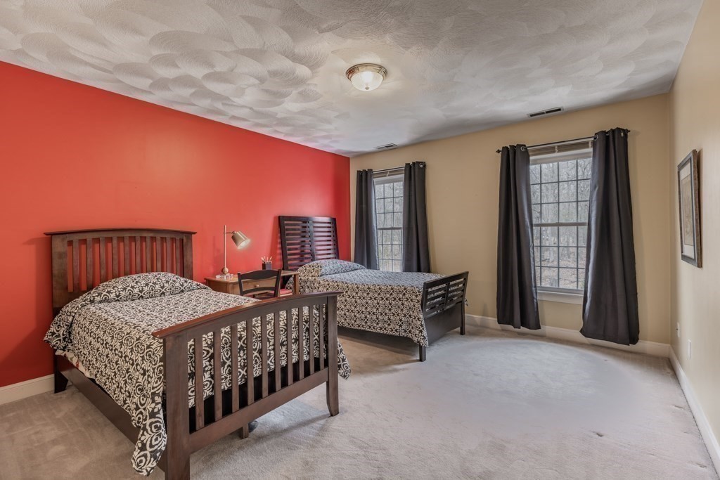 4 Walker Lane Boxford, MA 01921 - Photo 28 of 40 a bedroom with a bed and a chandelier