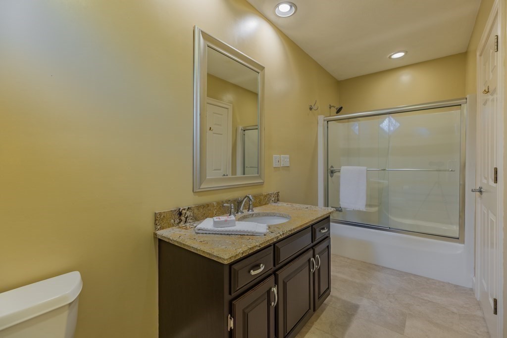 4 Walker Lane Boxford, MA 01921 - Photo 30 of 40 a bathroom with a granite countertop sink mirror and a shower