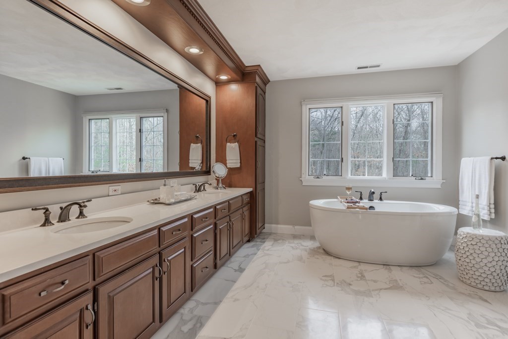 4 Walker Lane Boxford, MA 01921 - Photo 35 of 40 a spacious bathroom with sink double vanity mirror and bathtub