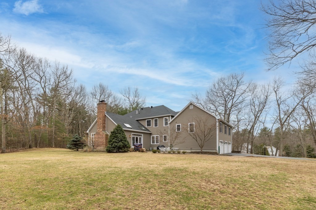 4 Walker Lane Boxford, MA 01921 - Photo 38 of 40 a front view of house with yard and trees in the background