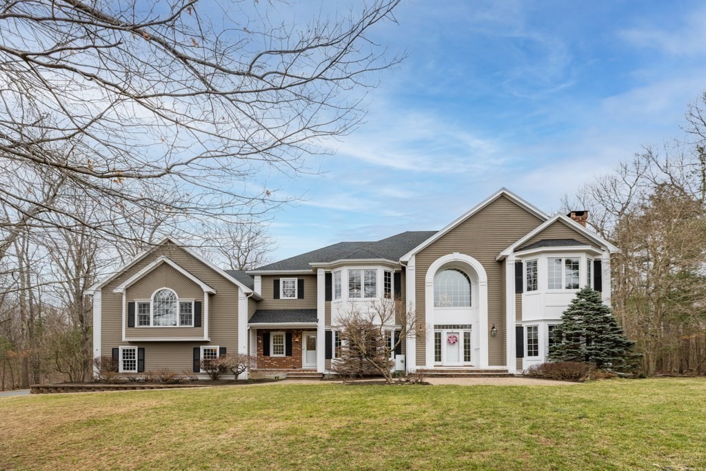 4 Walker Lane Boxford, MA 01921 - Photo 40 of 40 a front view of a house with large windows and a tree