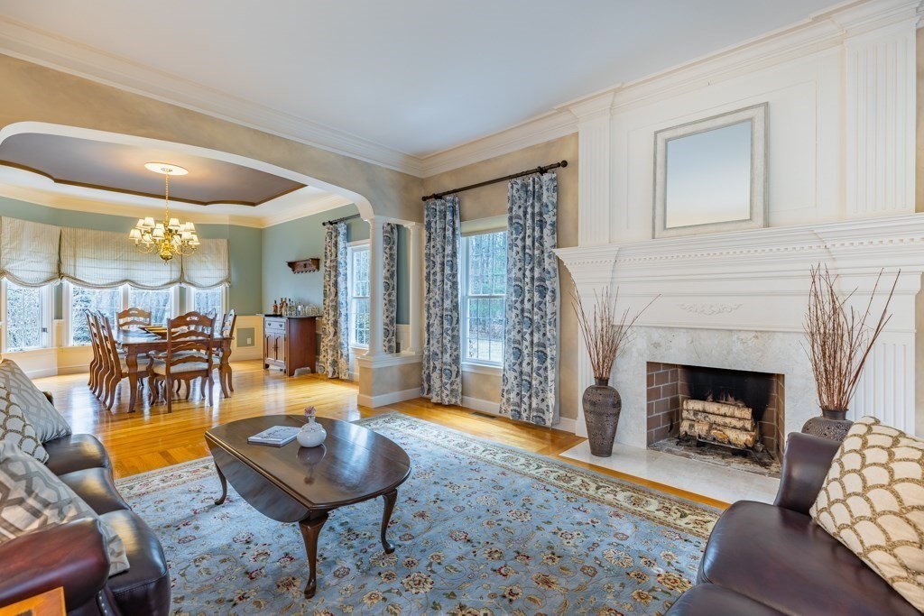 4 Walker Lane Boxford, MA 01921 - Photo 8 of 40 a living room with furniture a fireplace and a table
