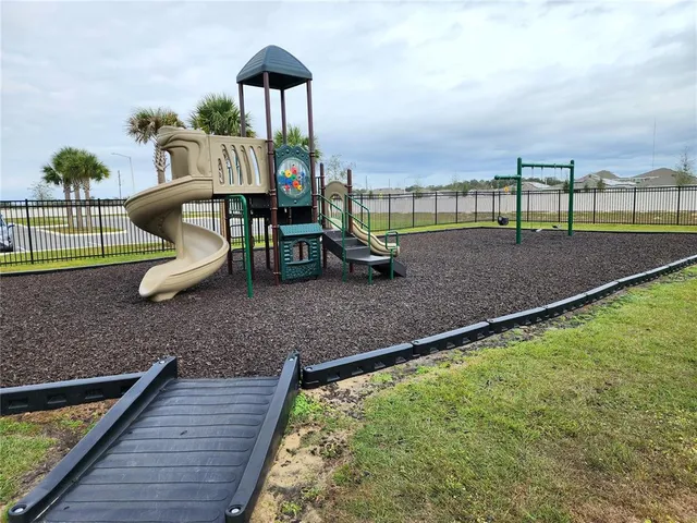 a view of a house with pool and a yard