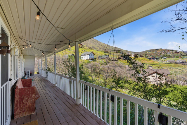 380 Luzern Road Midway, UT 84049 - Photo 35 of 74 Expansive covered porch featuring wood-finish flooring, white railing, and string lighting