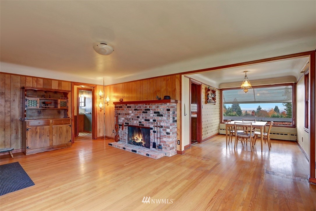 925 Southwest Langston Road Renton, WA 98057 - Photo 8 of 23 a living room with furniture and a fireplace