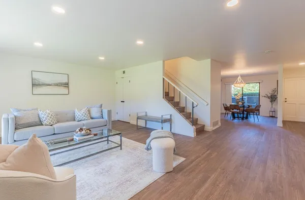 a living room with furniture and a wooden floor