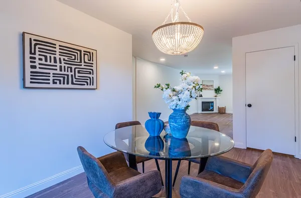 a view of a dining room with furniture and wooden floor