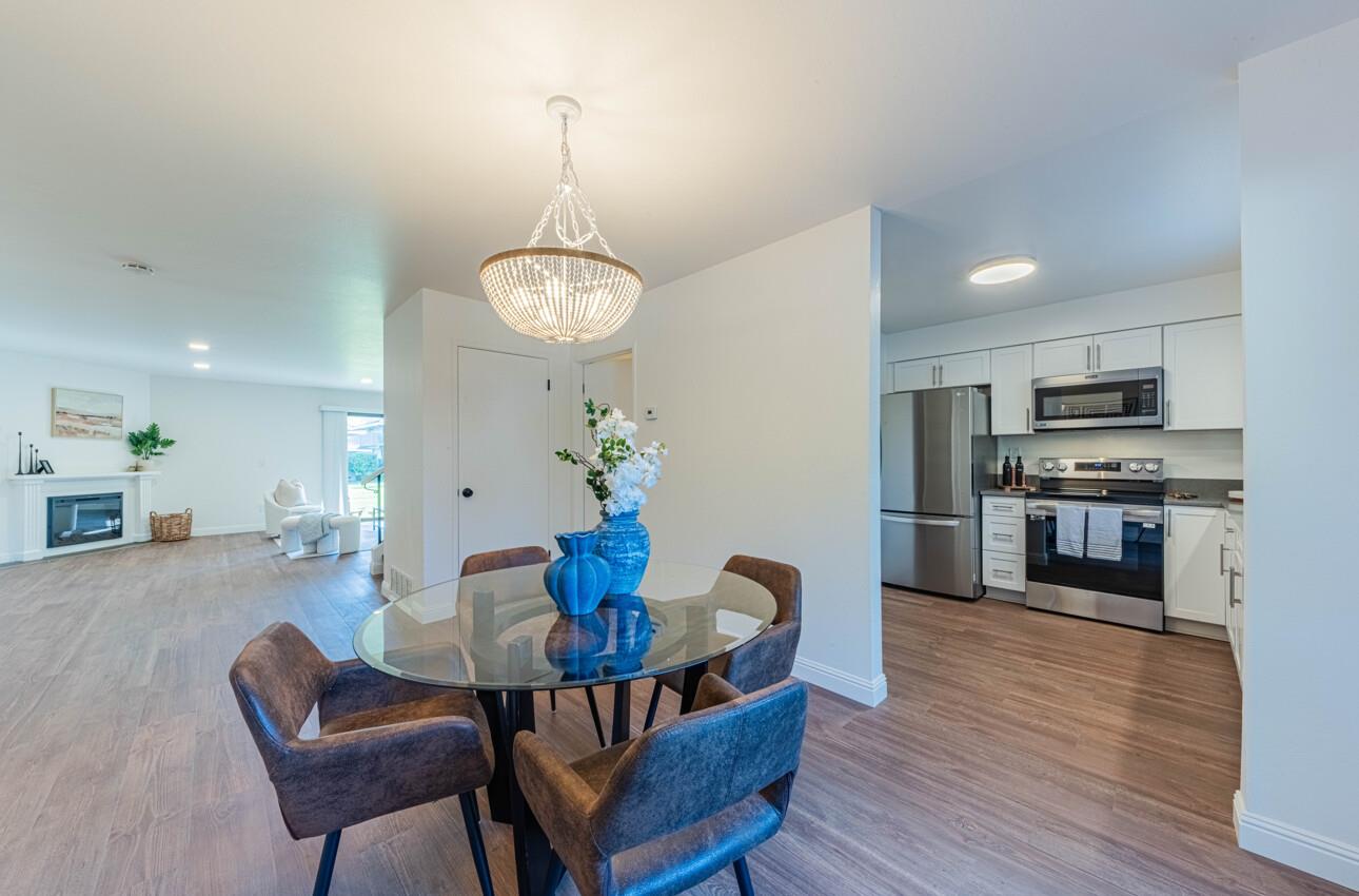 3850 Rio Road, Unit 24 Carmel, CA 93923 - Photo 14 of 39 a view of a dining room with furniture and wooden floor