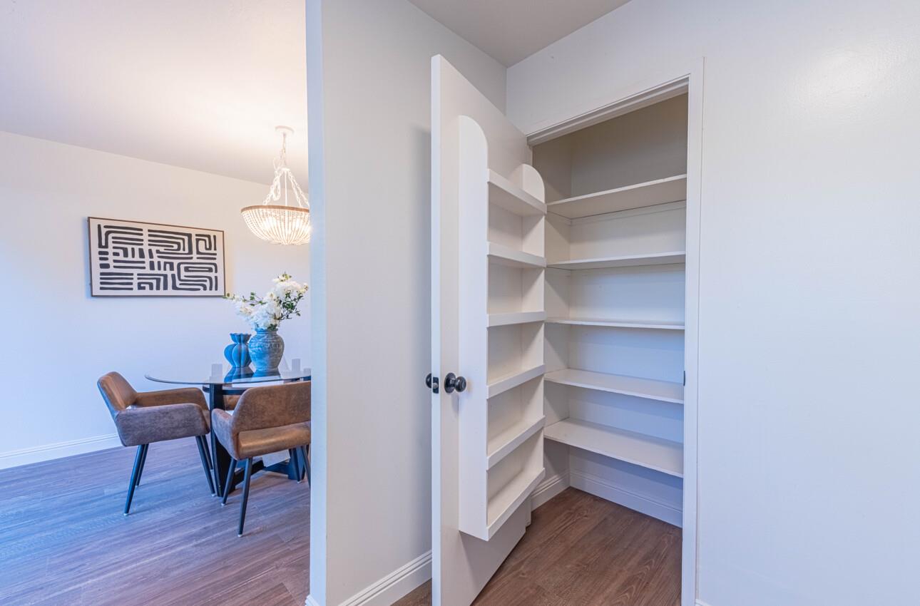 3850 Rio Road, Unit 24 Carmel, CA 93923 - Photo 16 of 39 a view of a hallway with wooden floor and a workspace