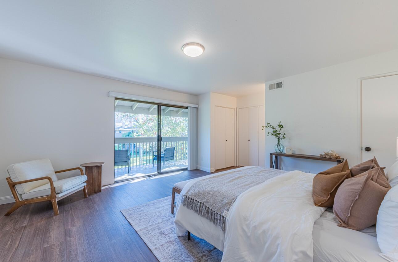 3850 Rio Road, Unit 24 Carmel, CA 93923 - Photo 21 of 39 a bedroom with a bed and a chair