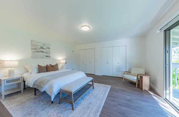 a spacious bedroom with a bed and a table